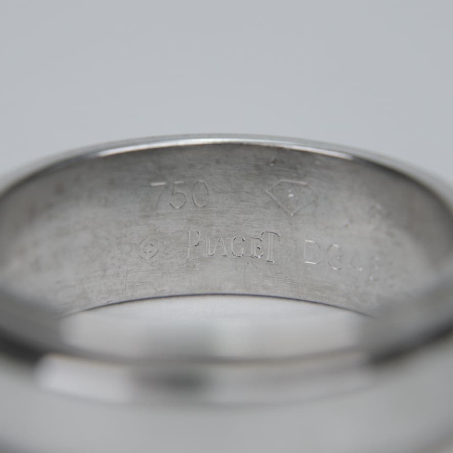 Close-up of silver ring with engravings.