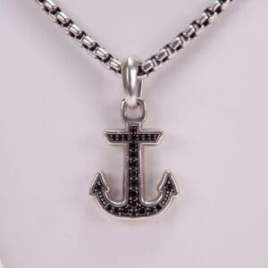 Anchor pendant on silver chain necklace.