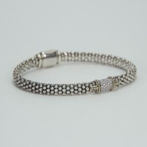 Silver beaded bracelet with decorative clasp.