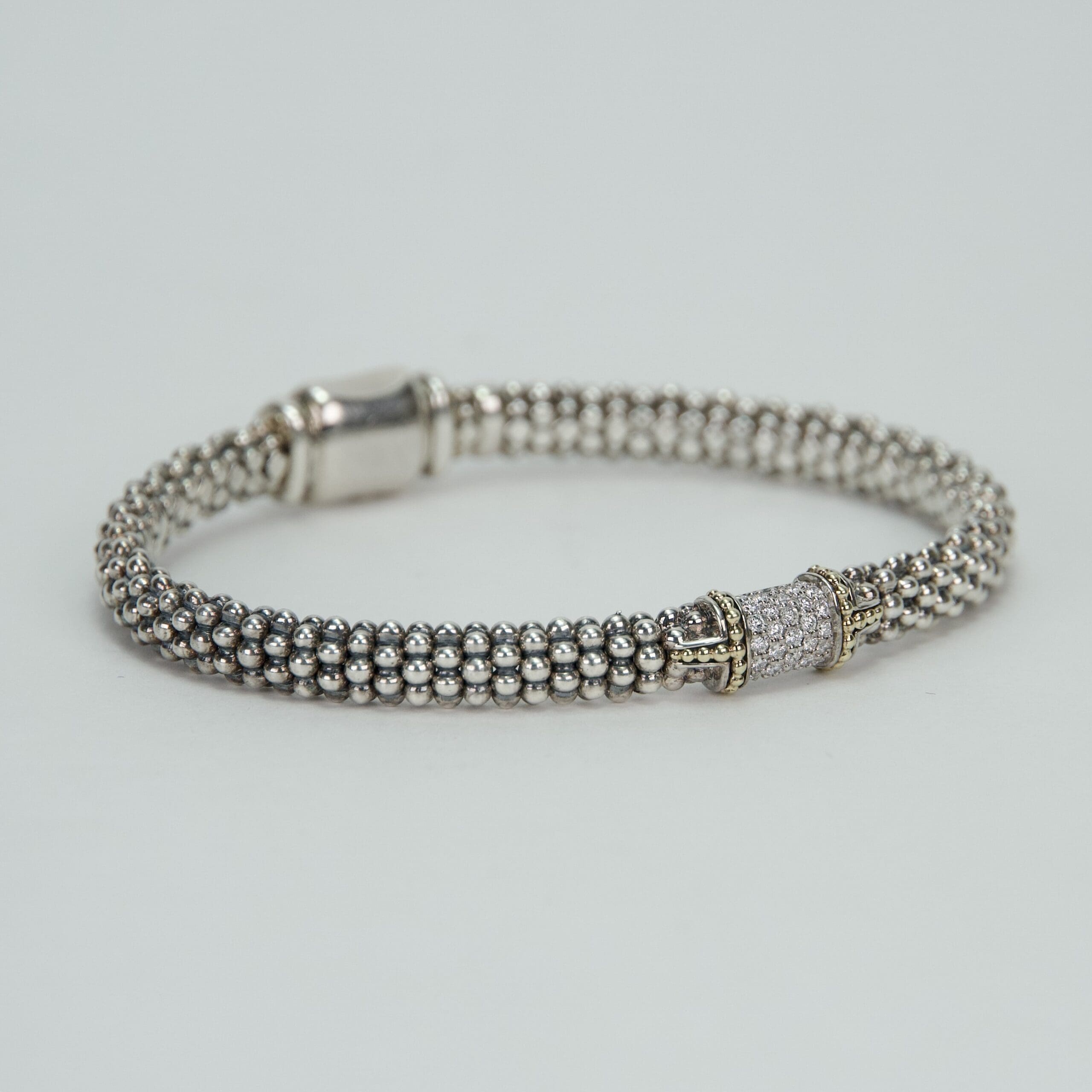 Silver beaded bracelet with decorative clasp.