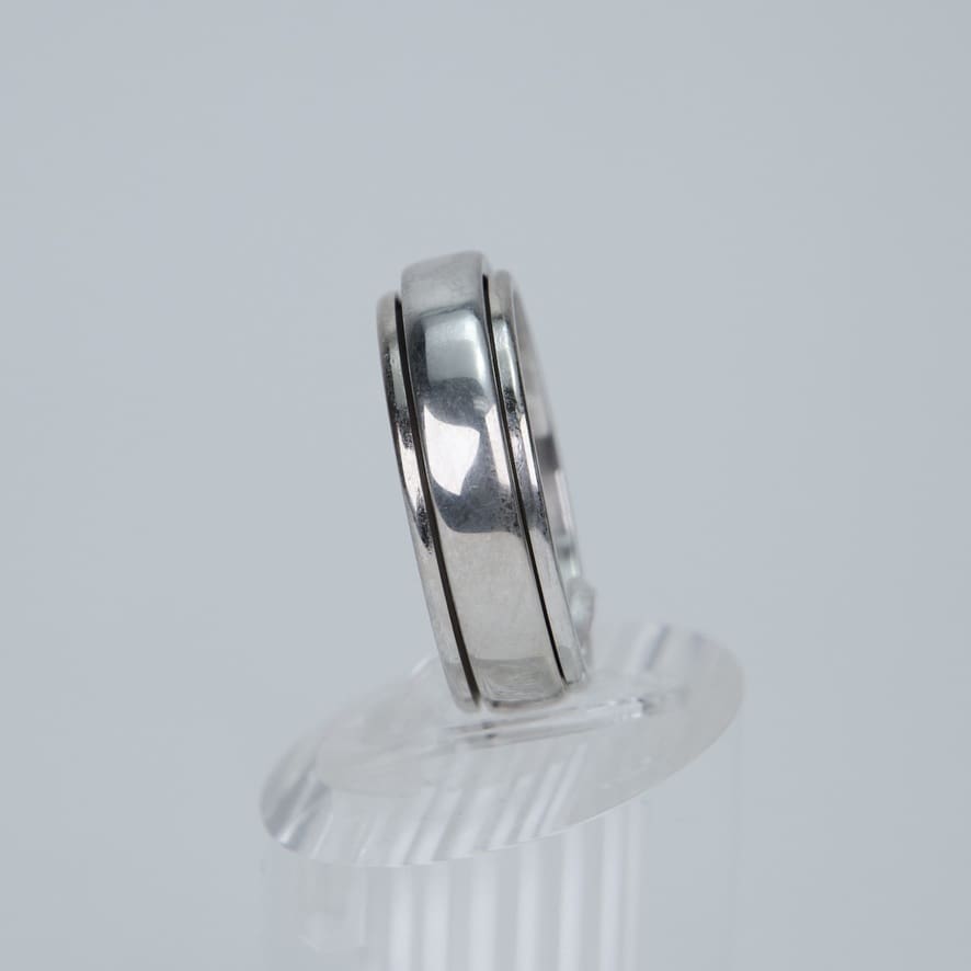 Silver ring on clear display stand.
