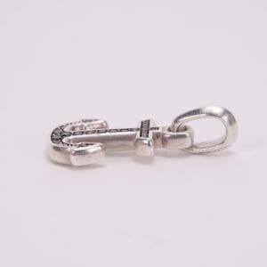 Silver anchor-shaped jewelry pendant on white background.