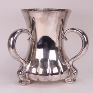 Silver decorative vase with two ornate handles.