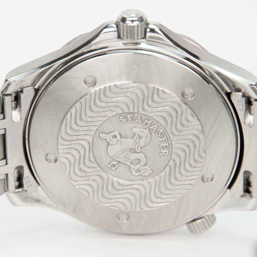 Back of a Seamaster watch with engravings.