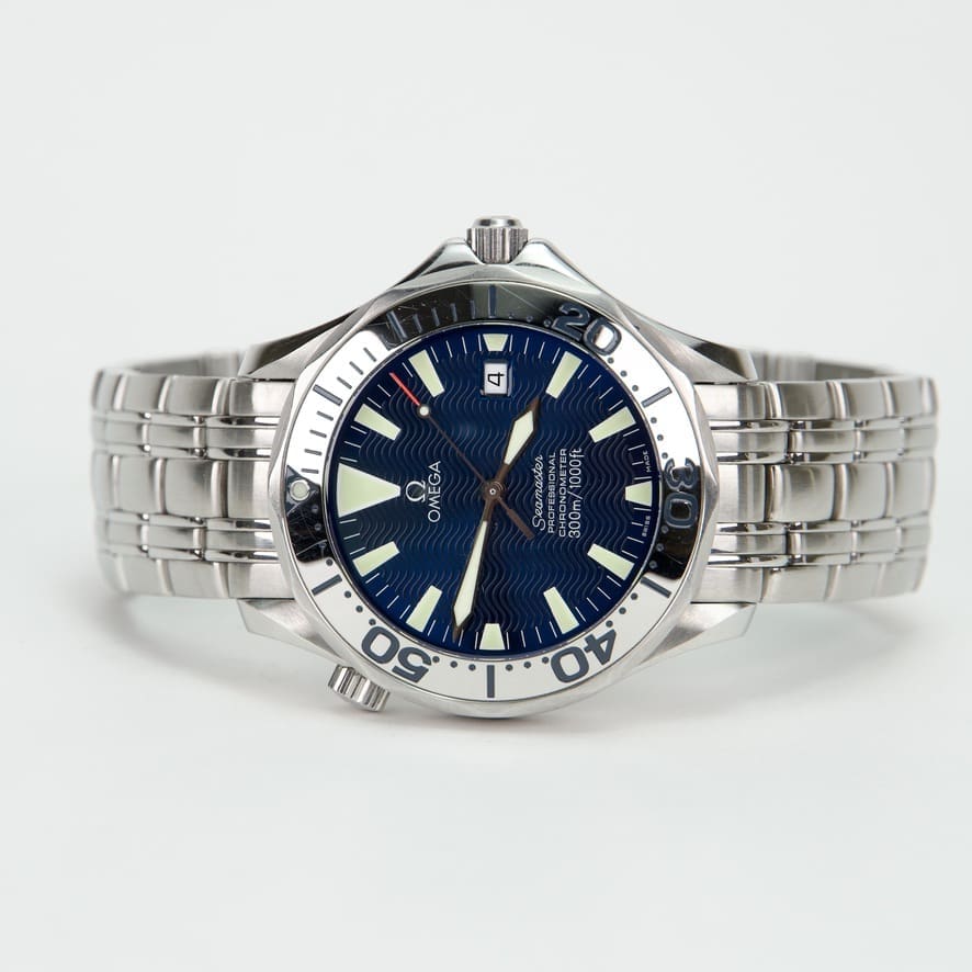 Silver wristwatch with blue dial face.