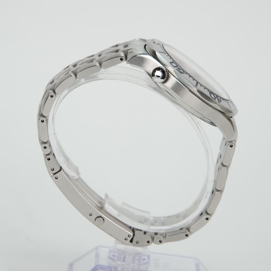 Silver wristwatch with metal strap, side view.