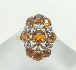Gold ring with amber and clear stones.