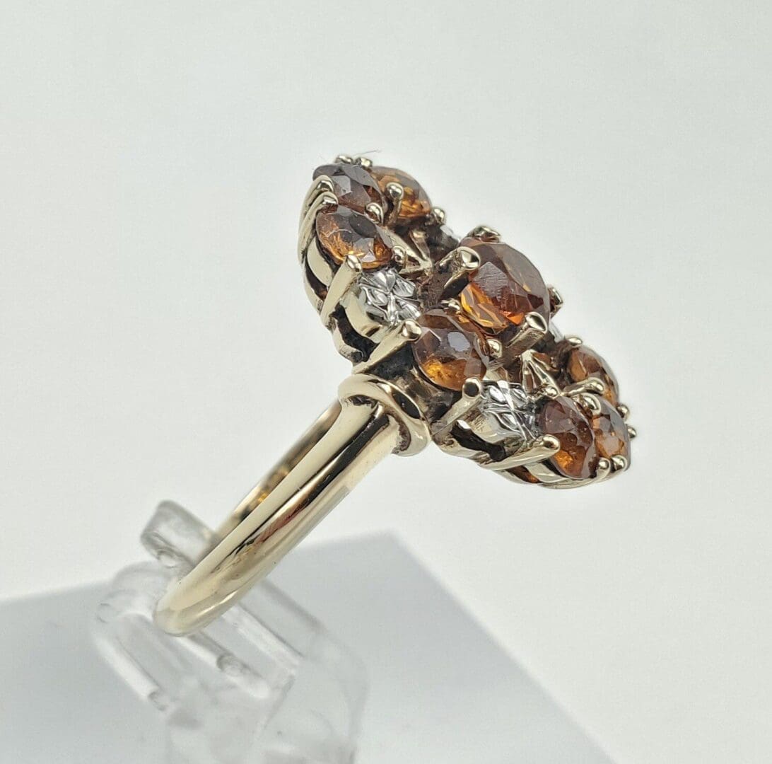 Gold ring with brown and white gemstones.