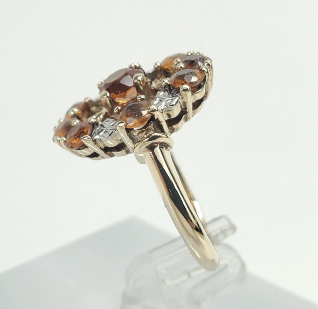 Gold ring with brown and clear gemstones.