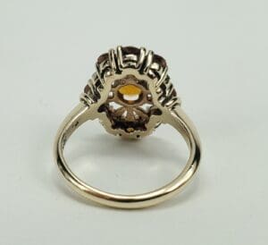 Gold ring with intricate gemstone setting.