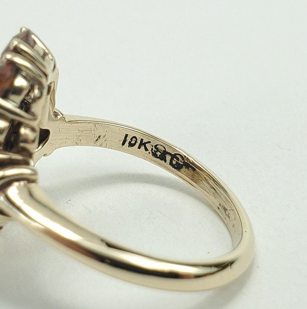 Gold ring with "18K" hallmark inside band.