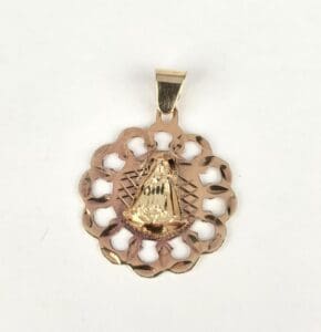 Gold pendant with intricate design.