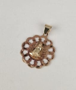 Gold pendant with intricate cutout design.