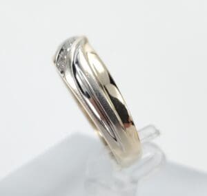 Gold and silver wedding band on display.