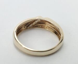 Gold ring with engraved details inside.