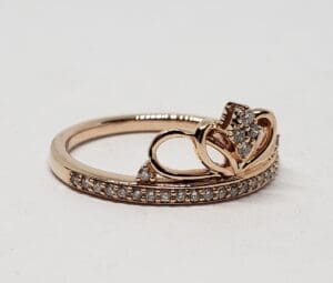 Gold ring with diamonds and heart design.