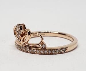 Gold ring with diamond accents on band.