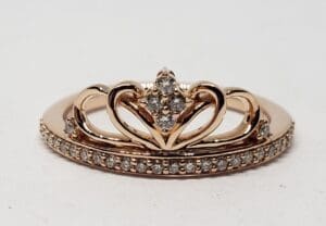 Gold ring with heart-shaped diamond design.