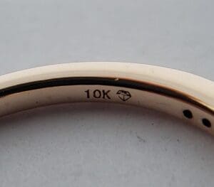 Gold ring with 10K diamond engraving.