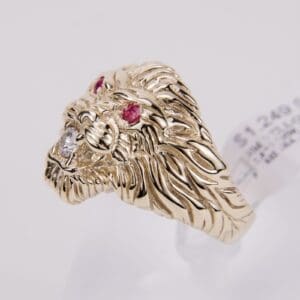 Gold lion head ring with gemstones.