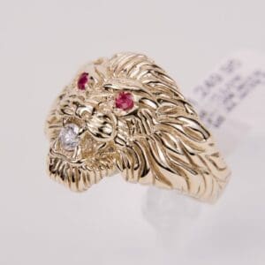 Gold lion ring with gemstone eyes.