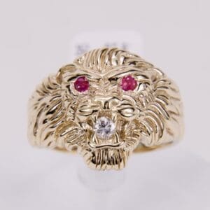 Gold lion ring with gemstone eyes.