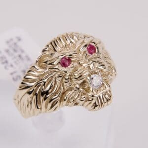 Gold lion ring with ruby eyes.