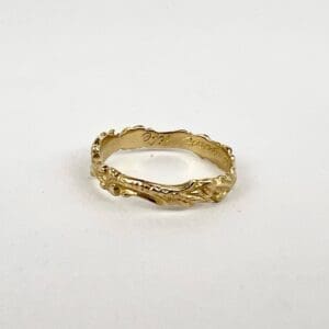 Gold ring with textured, organic design.