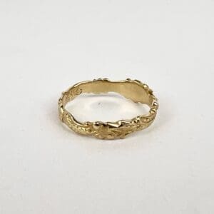 Gold ring with intricate leaf design.