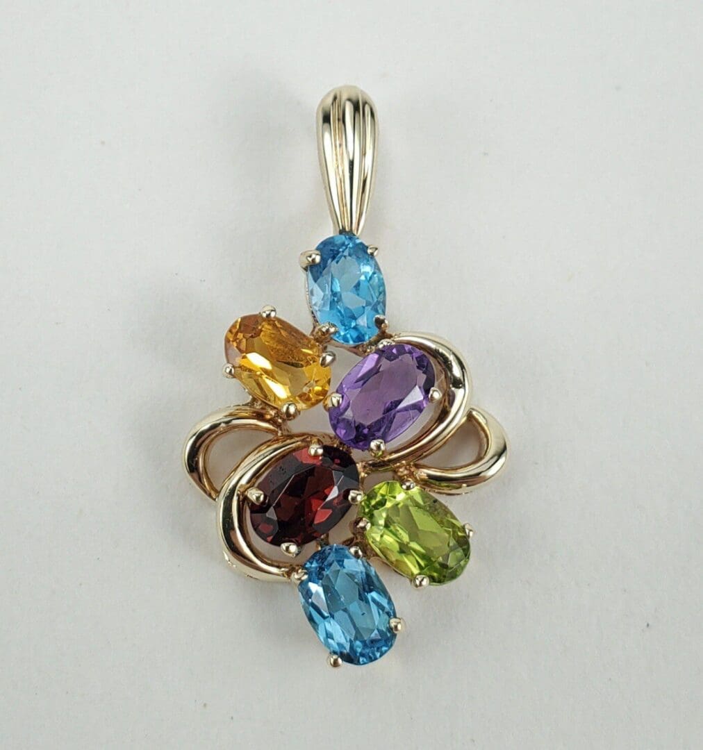 Colorful gemstone pendant with silver accents.