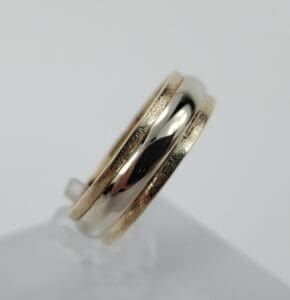 Gold and silver two-tone ring on display.