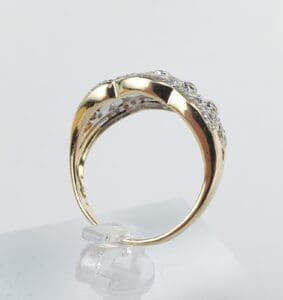 Gold ring with diamond accents on display.