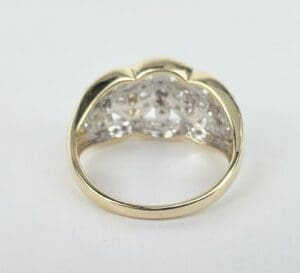 Gold ring with intricate cutout design.