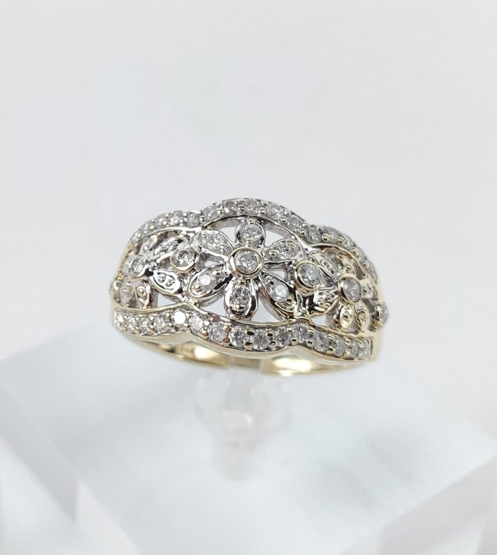 Ornate diamond ring with floral design.