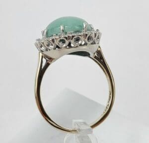 Gold ring with large green gemstone.
