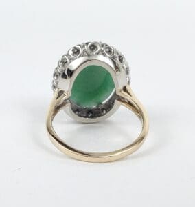 Gold ring with green gemstone setting.