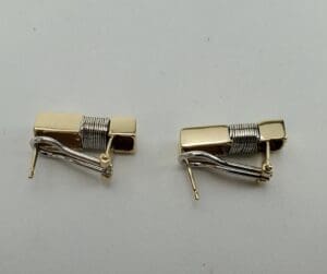 Gold and silver metal cufflinks on display.