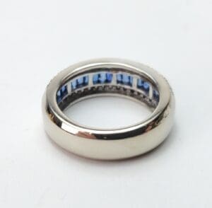 Silver ring with blue gemstones inside.