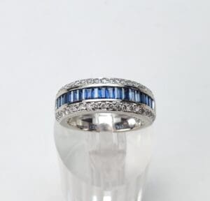 Silver ring with blue and clear stones.
