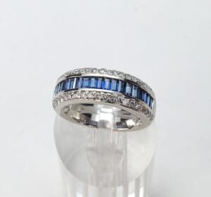 Silver ring with blue and clear stones.