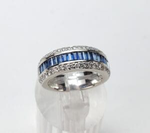 Silver ring with blue and clear stones.