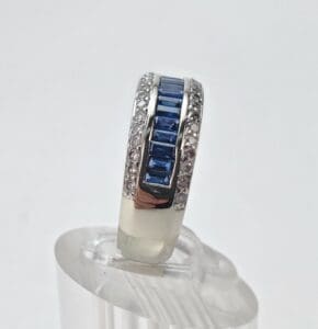 Silver ring with blue and clear stones.
