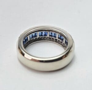 Silver ring with blue gemstone accents.