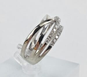 Silver ring with diamond accents on display.
