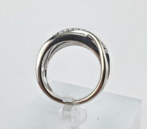 Silver ring with small diamonds on display.