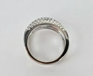 Silver ring with textured design on top.