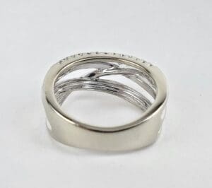 Silver ring with intertwined band design.