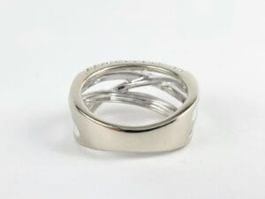 Silver intertwined band ring on display.