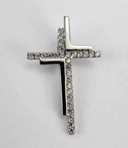Silver cross pendant with embedded diamonds.