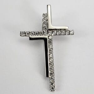 Silver cross pendant with embedded diamonds.